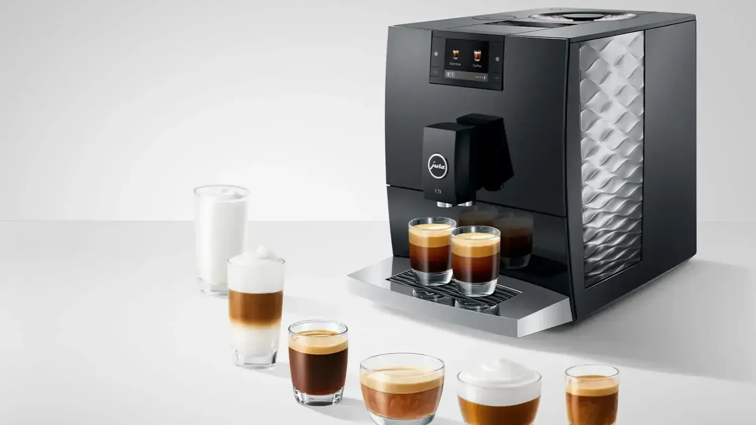 The JURA C9 coffee machine with a range fo coffees in front of it