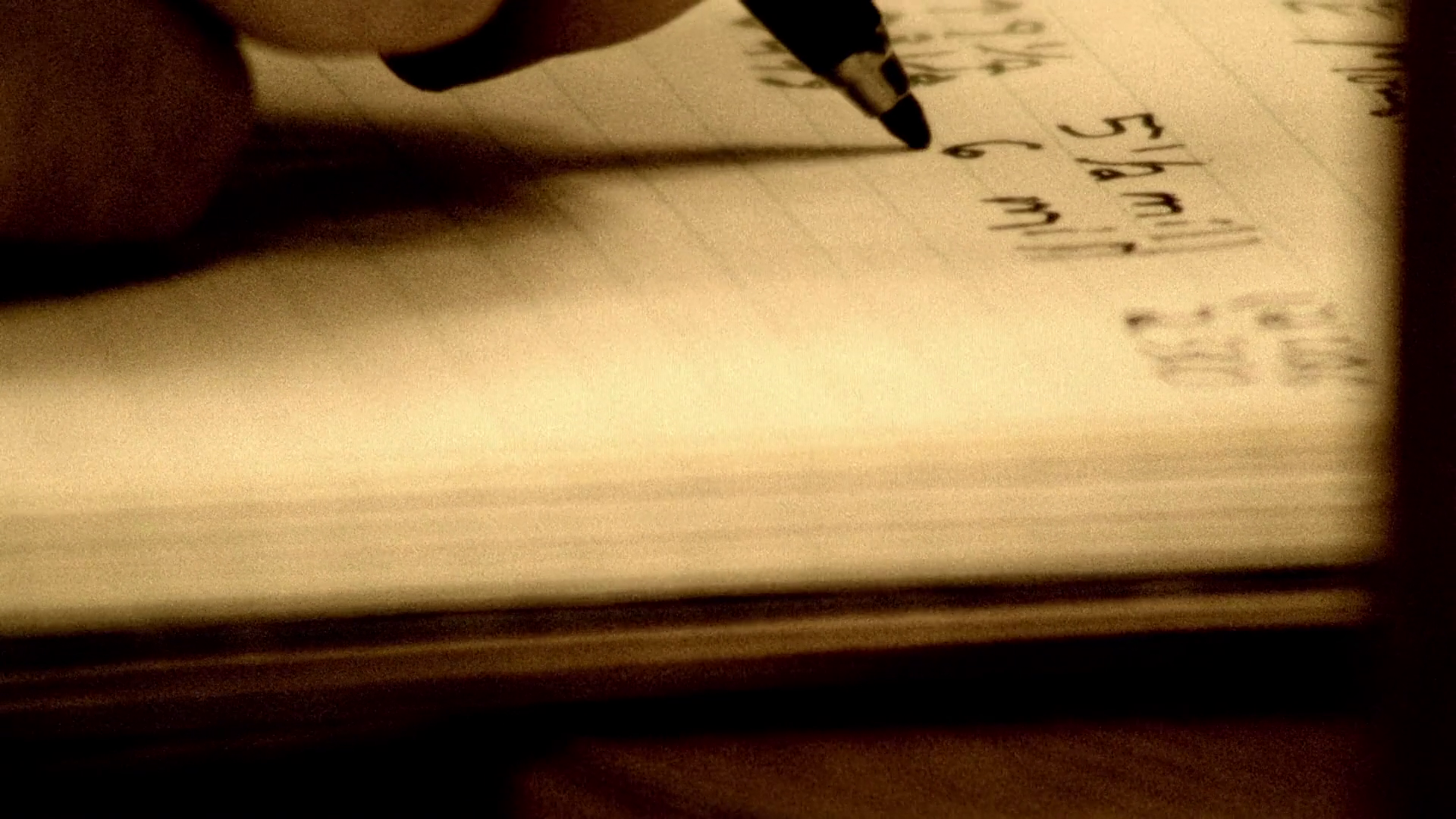 A close-up view of an open notebook page filled with meticulous handwritten mathematical calculations and stock market ticker symbols.