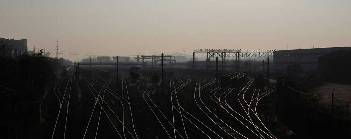 An Aerial shot of train tracks naturally leads the viewer’s eye down the page while subtly communicating path selection and convergence.