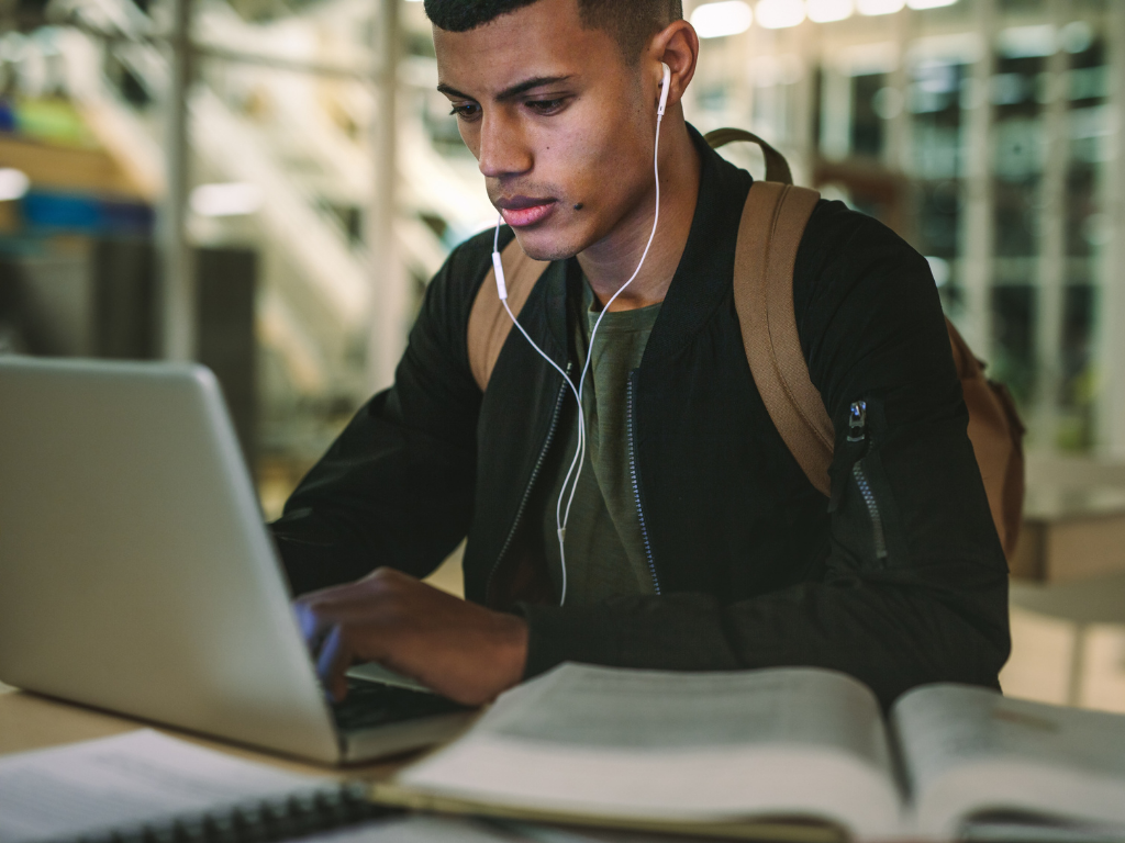 Man studying in front of laptop to become a NASM certified personal trainer&nbsp;