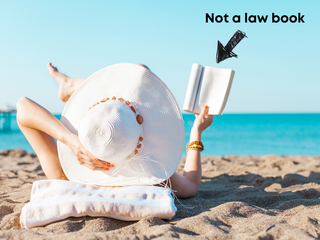 Woman reading a book at the beach labeled "Not a law book"