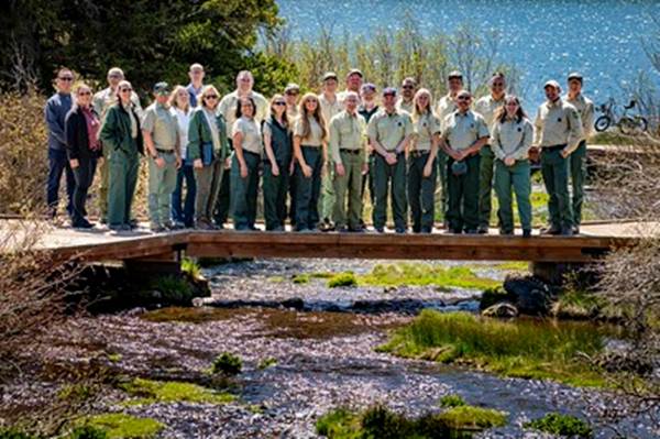 A group of people standing on a bridge over a river

AI-generated content may be incorrect.