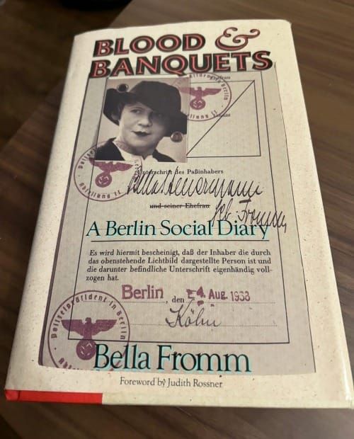 Cover of "Blood & Banquets: A Berlin Social Diary" by Bella Fromm. Features a sepia-toned passport-style photo and official stamps, with a vintage, historical feel.