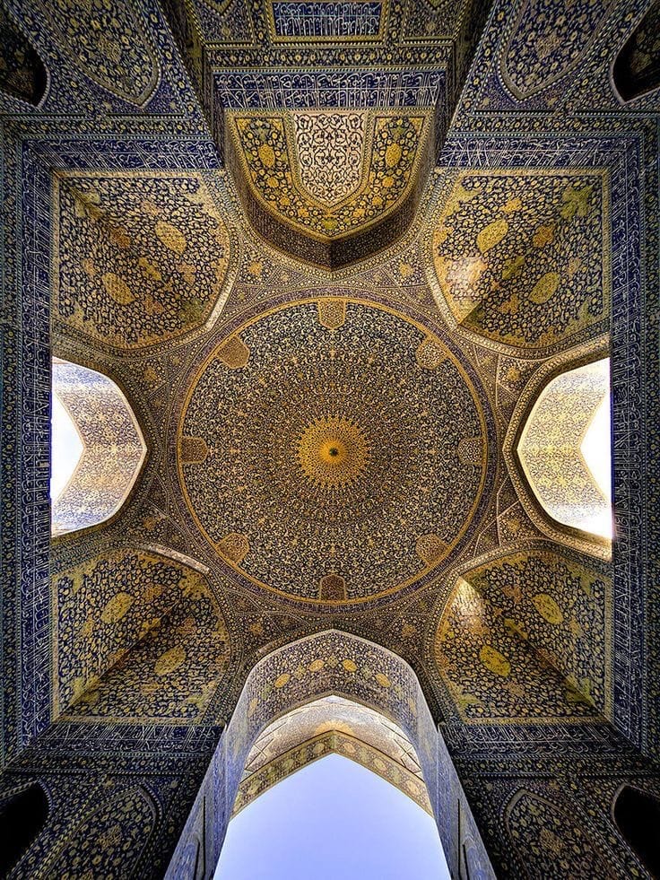 Gazing upwards into an ornately decorated Iranian hall with a spectacular circular centrepiece.