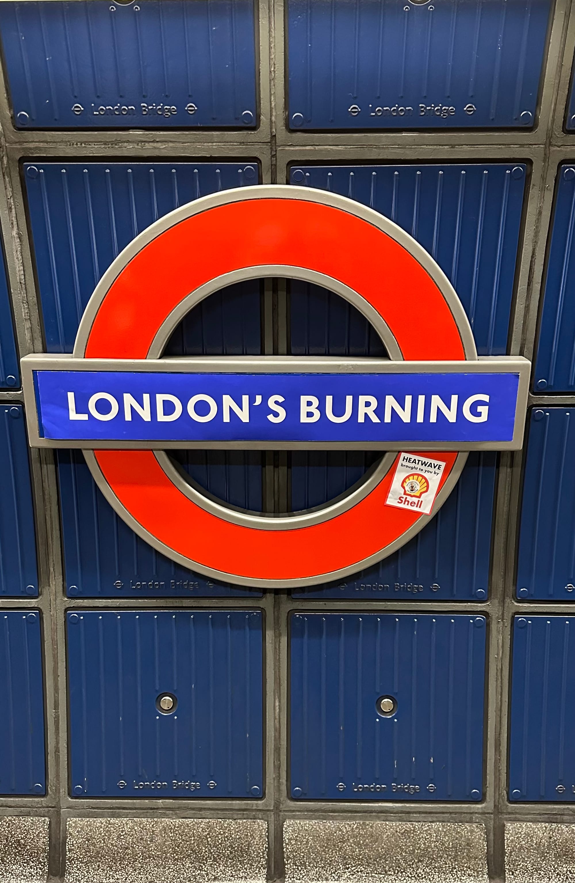 London Underground roundel modded by Greenpeace to read "LONDON'S BURNING".