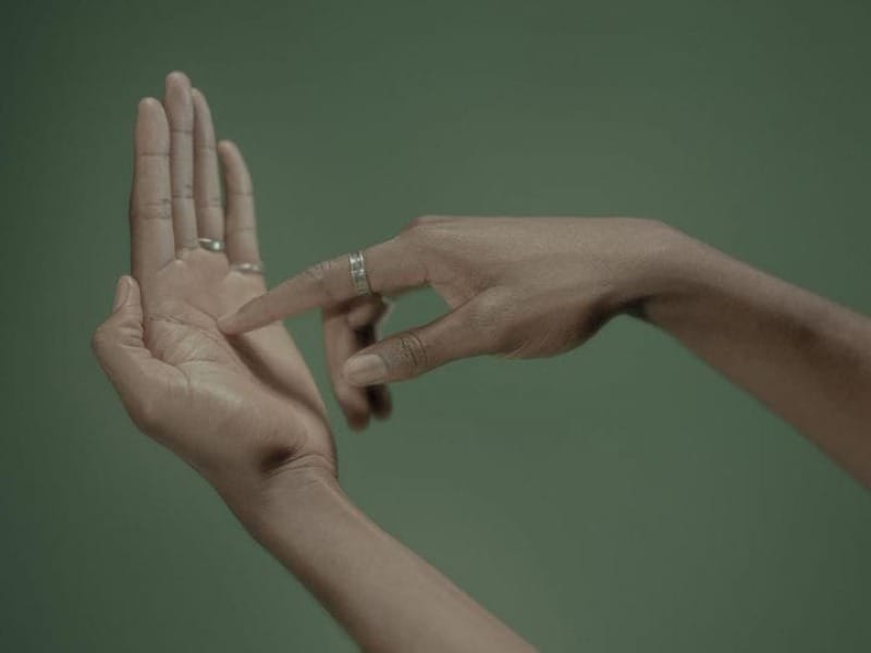 untitled, from the series Death by GPS by Salvatore Vitale, a photo of a person's hands gesturing as if they are swiping a phone that is not there.