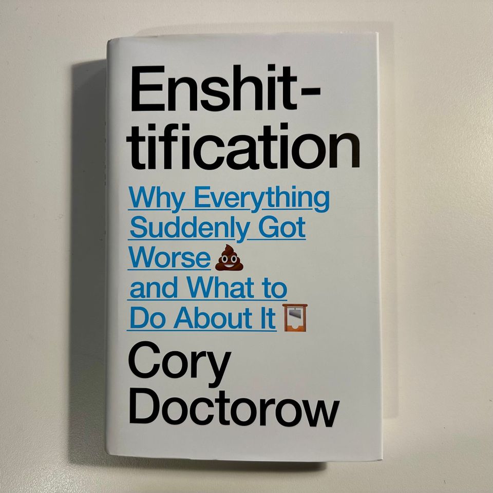 Photo of a book "Enshittification: Why Everything Suddenly Got Worse and What to Do About It, by Cory Doctorow, on a white table.