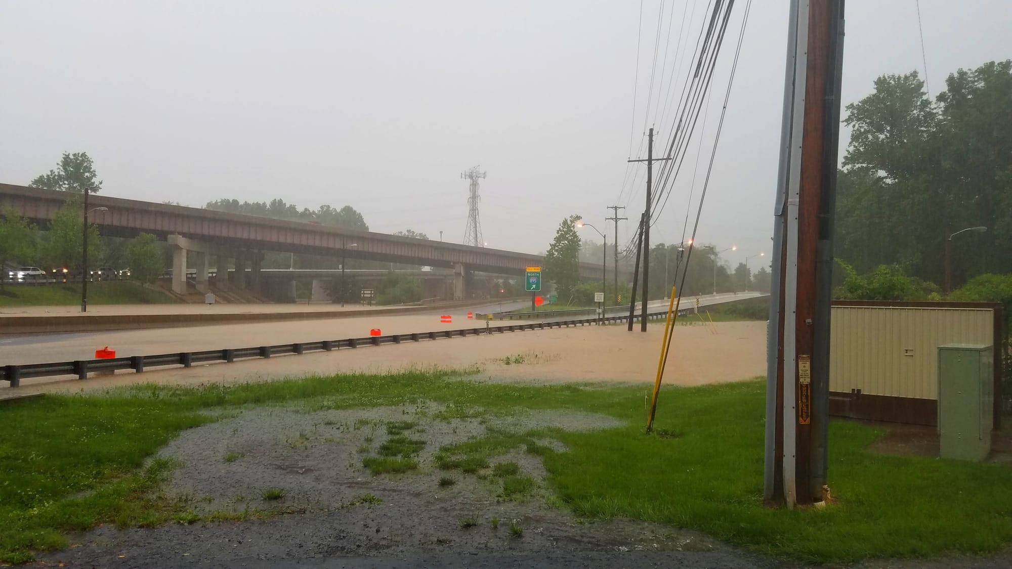 Water from the Patapsco River running downstream from Ellicott City floods U.S. Route 1 and the entrance to Interstate I-895 in Elkridge, Maryland. 2018.