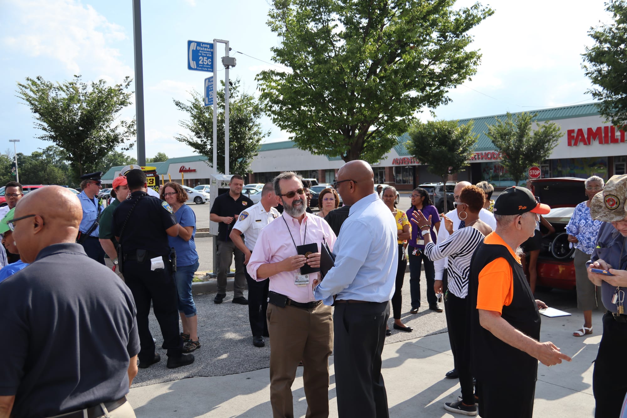 Police and community leaders and members congregate during a peace march at Alameda Shopping Center, Baltimore. 2019.