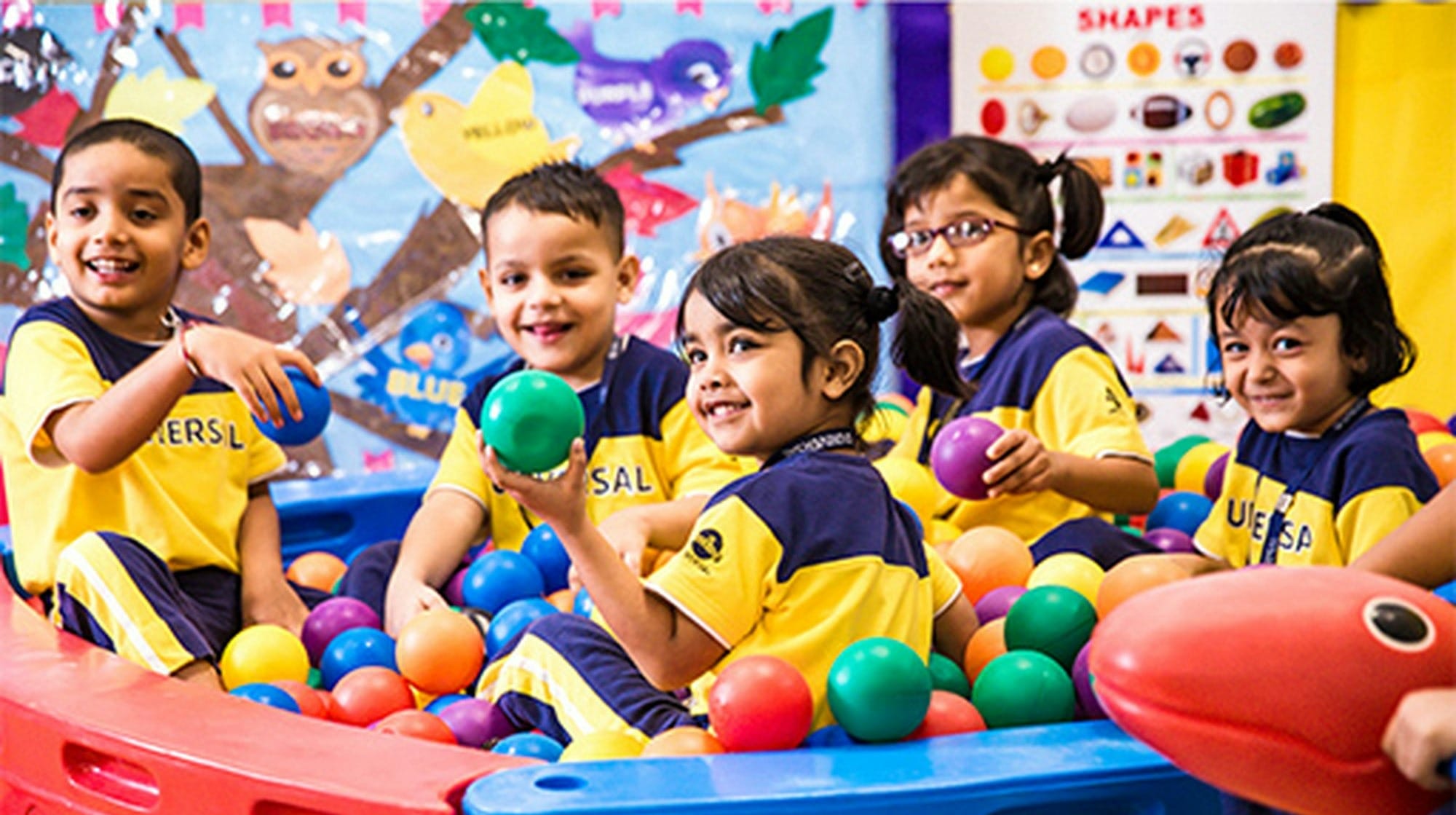 A group of children playing in a ball pit