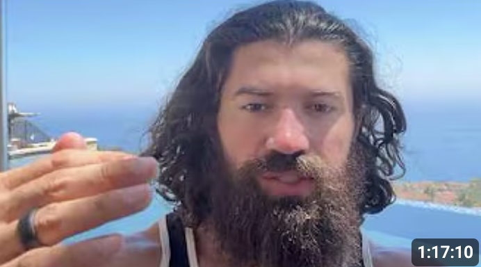 A phone video of Alex Hormozi talking to camera outdoors