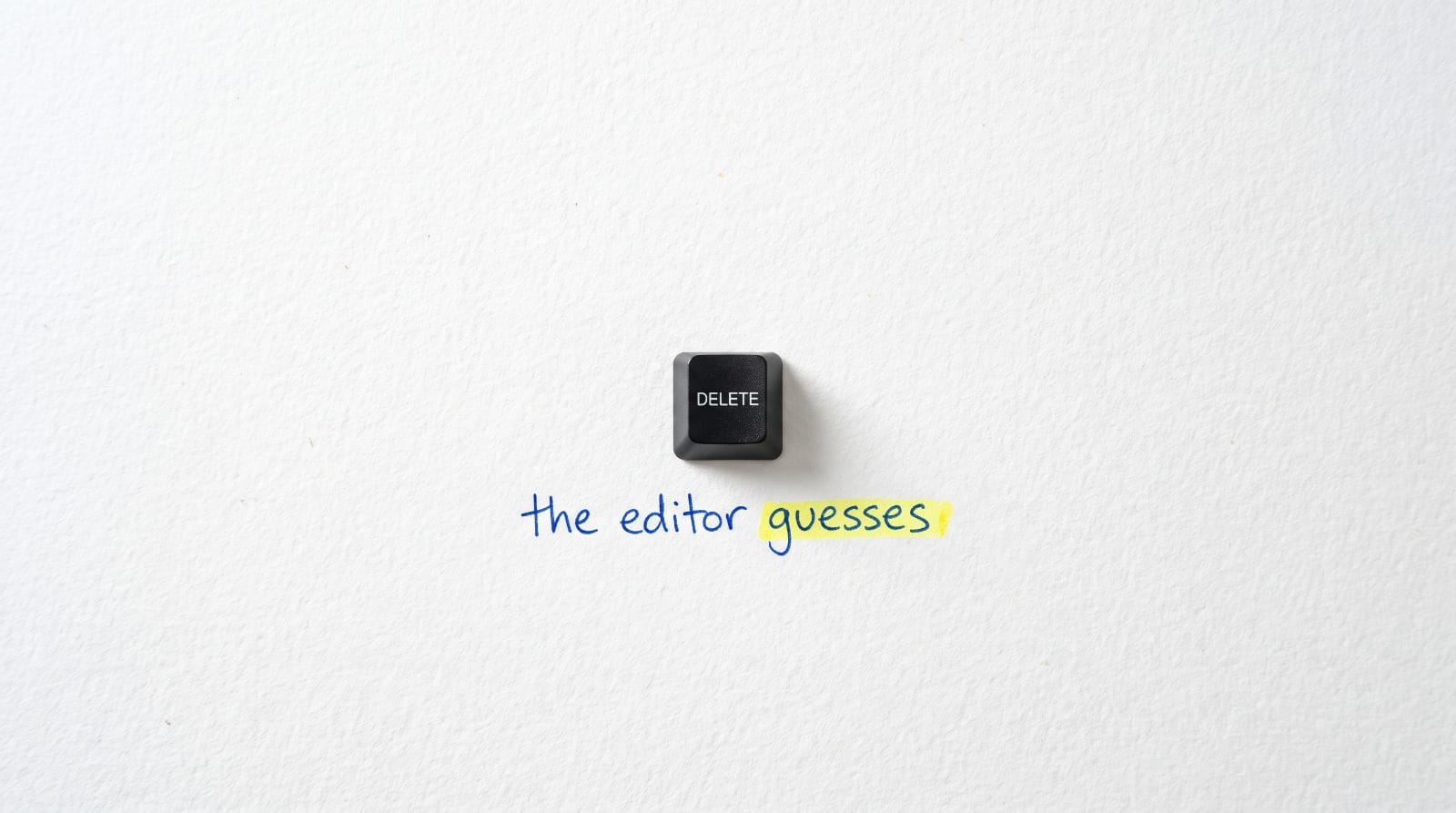 A single black keyboard key on white paper with the handwritten words: the editor guesses. The word guesses is highlighted.