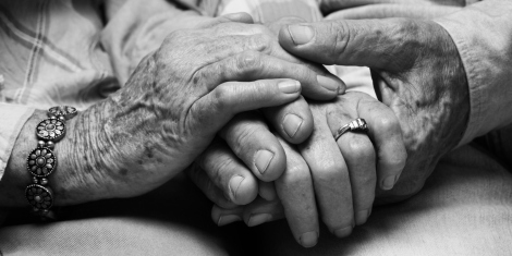 Senior couple holding hands, close up