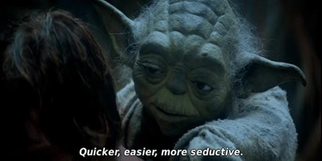 Yoda, a green muppet, talks into the ear of a hero-in-training