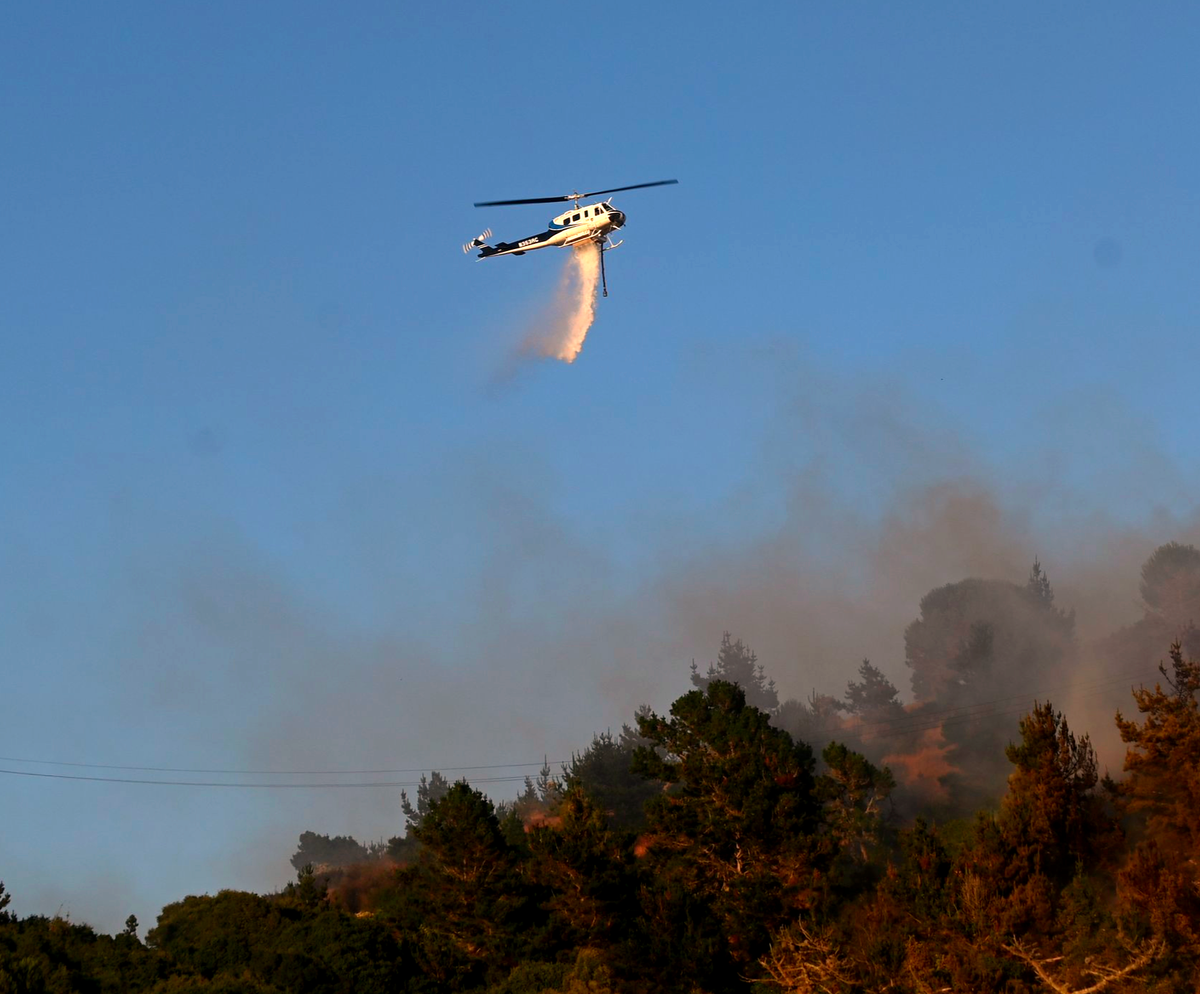 Helicopters assist ground crews fighting Dornan Drive fire