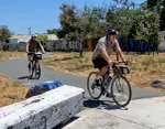 Cyclists at the Richmond Greenway trail gap at Carlson Boulevard, where riders detour onto city streets to continue.