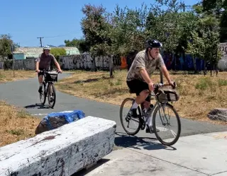 Cyclists at the Richmond Greenway trail gap at Carlson Boulevard, where riders detour onto city streets to continue.