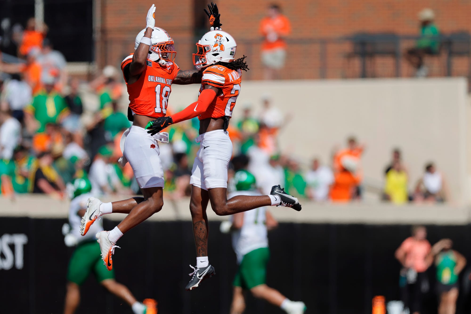 STILLWATER, OKLAHOMA - SEPTEMBER 12: Safety Mose Phillips III #18 and safety Markeith Williams #25 of the Oklahoma State Cowboys celebrate after stopping the Oregon Ducks in the fourth quarter at Boone Pickens Stadium on September 12, 2026 in Stillwater, Oklahoma. Oklahoma State won 39-31. (Photo by Brian Bahr/Getty Images)