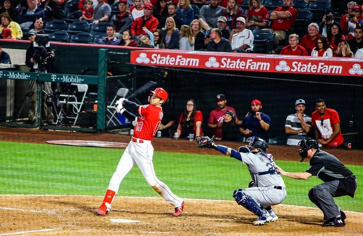 Anaheim Angels pitcher and outfielder Shohei Ohtani swings a bat in a game against the Seattle Mariners 