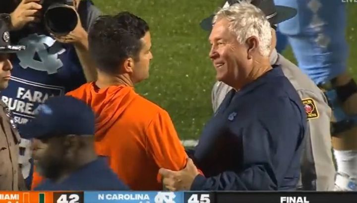 Mack Brown embraces Manny Diaz after the 2021 UNC/Miami game