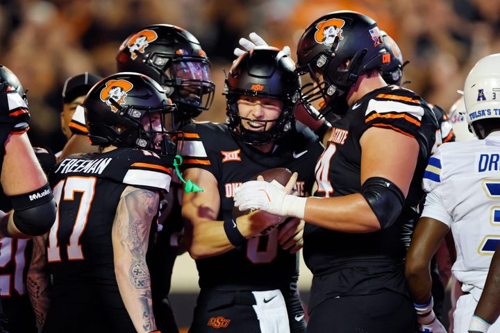 STILLWATER, OK - SEPTEMBER 19: Quarterback Zane Flores #6 of the Oklahoma State Cowboys celebrates a five-yard touchdown run against the Tulsa Golden Hurricane in the fourth quarter at Boone 