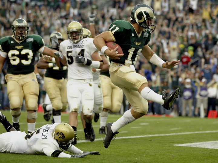 DENVER - AUGUST 30: Quarterback Bradlee Van Pelt #11 of the Colorado State University Rams high steps past safety J.J. Billingsley #5 of the University of Colorado Buffaloes during the game a