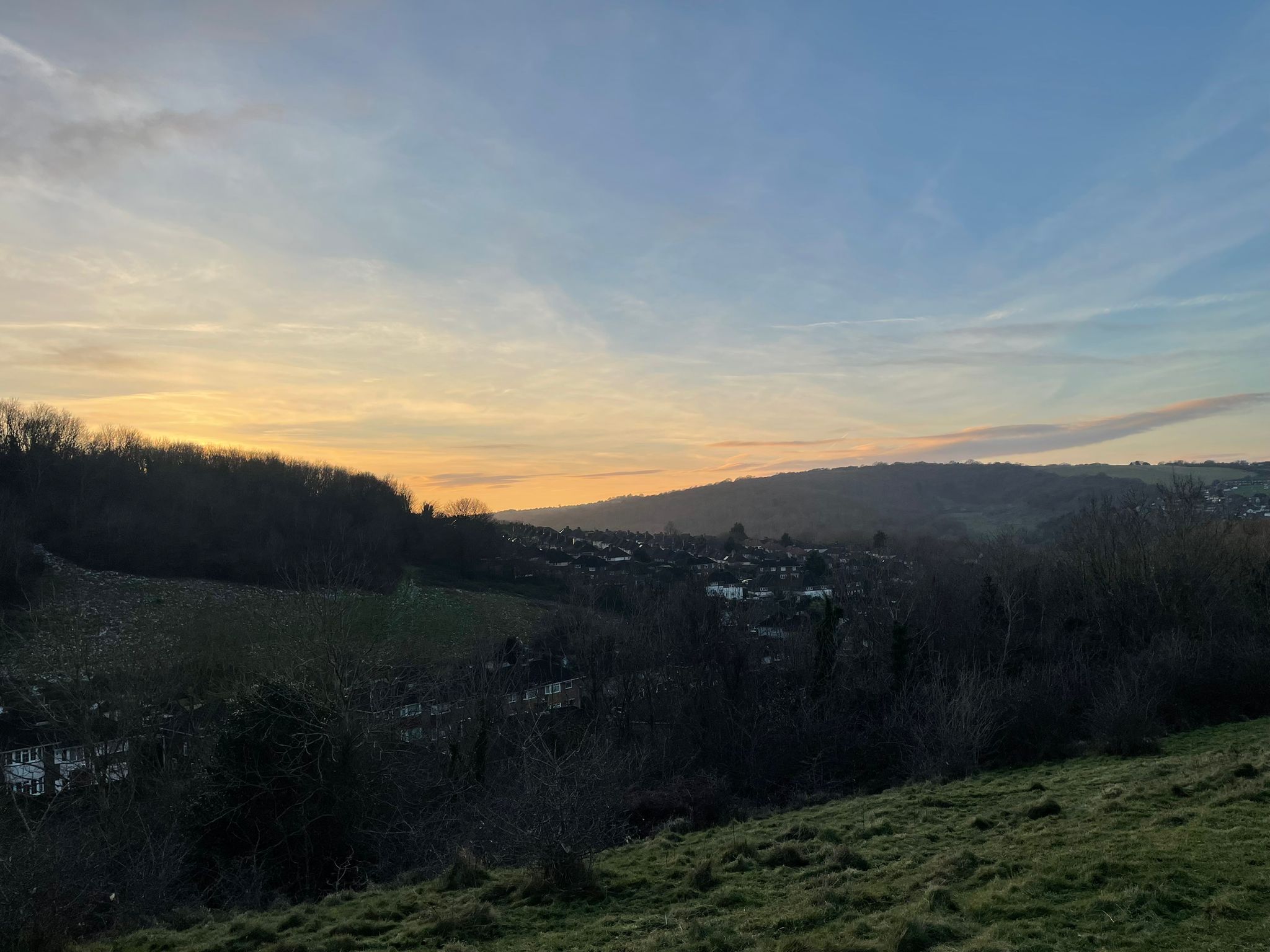 Sunset view of houses nestled in hills