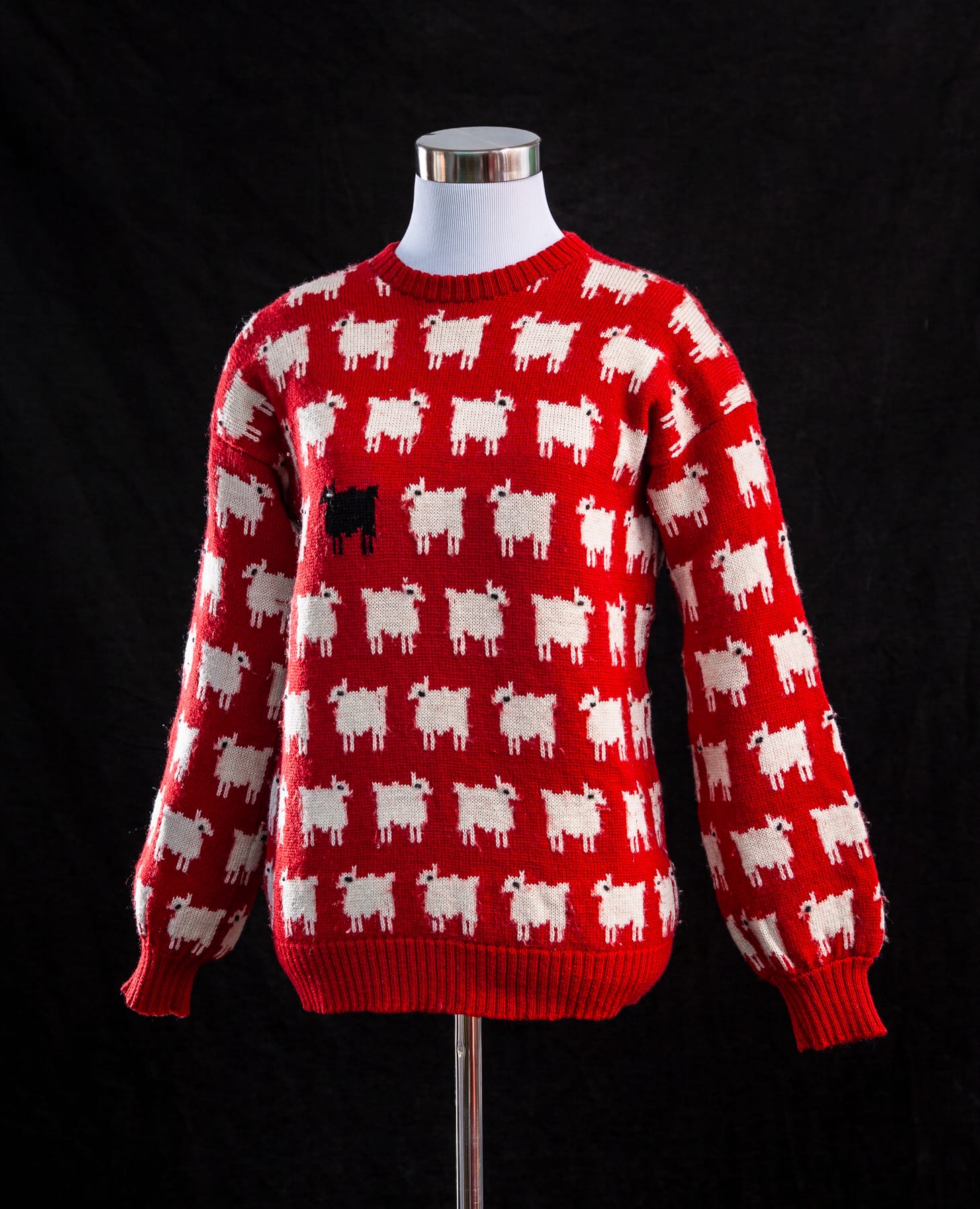 Image Credit: The Princess Diana Museum -- The iconic “Black Sheep Sweater,” designed by Sally Muir and Joanna Osborne. Its playful pattern, featuring a single black sheep among white ones, became a defining symbol of Princess Diana’s individuality and sense of humor.