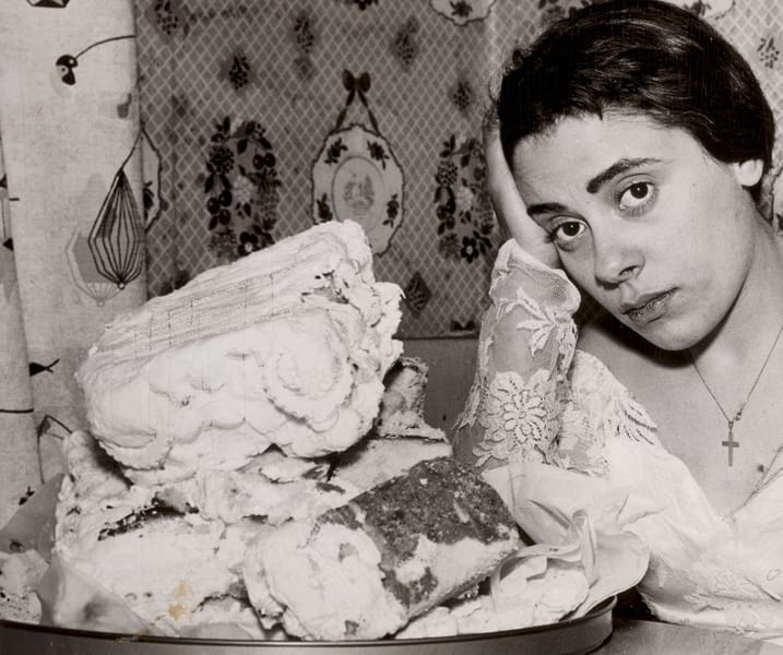 Bride with remains of her wedding cake after reception cut short by brawl