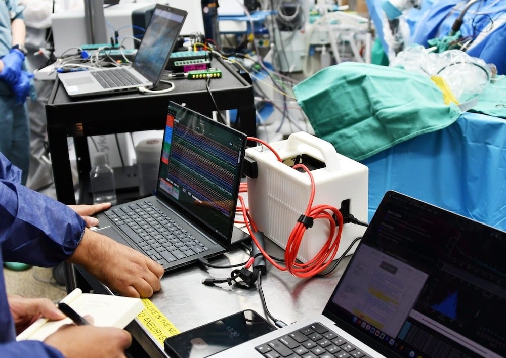 Computers capturing neural data during the first Connexus brain-computer interface surgery
