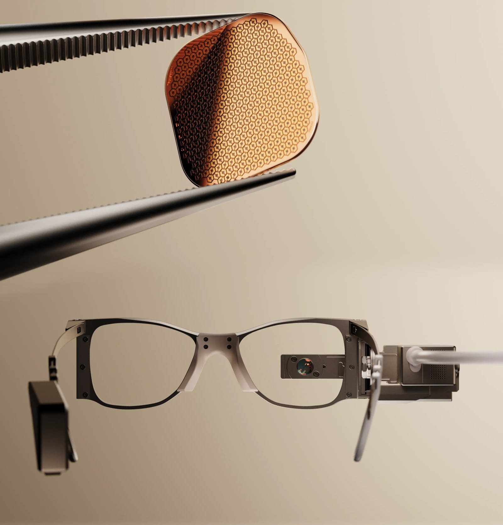 The PRIMA subretinal implant, 2mm square, held between tweezers alongside the PRIMA camera glasses