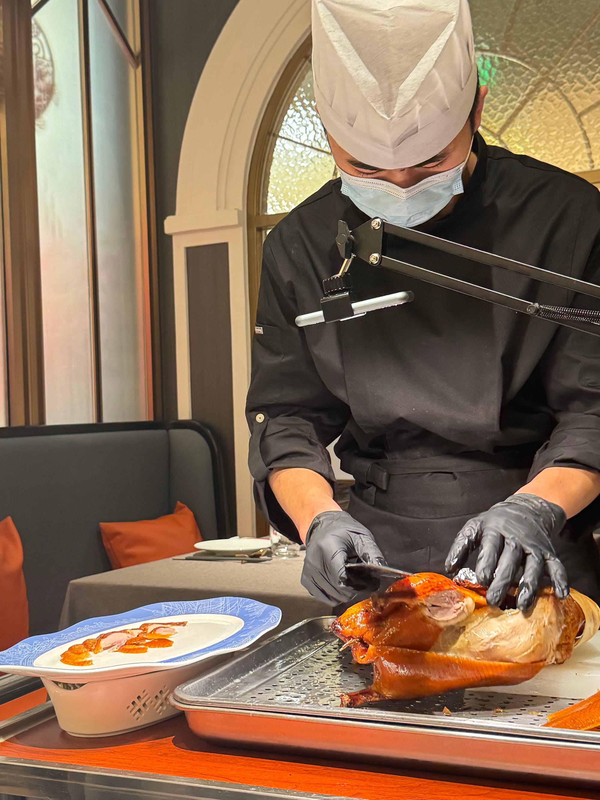 Chef cutting a Peking or Beijing duck in Shanghai Guniang