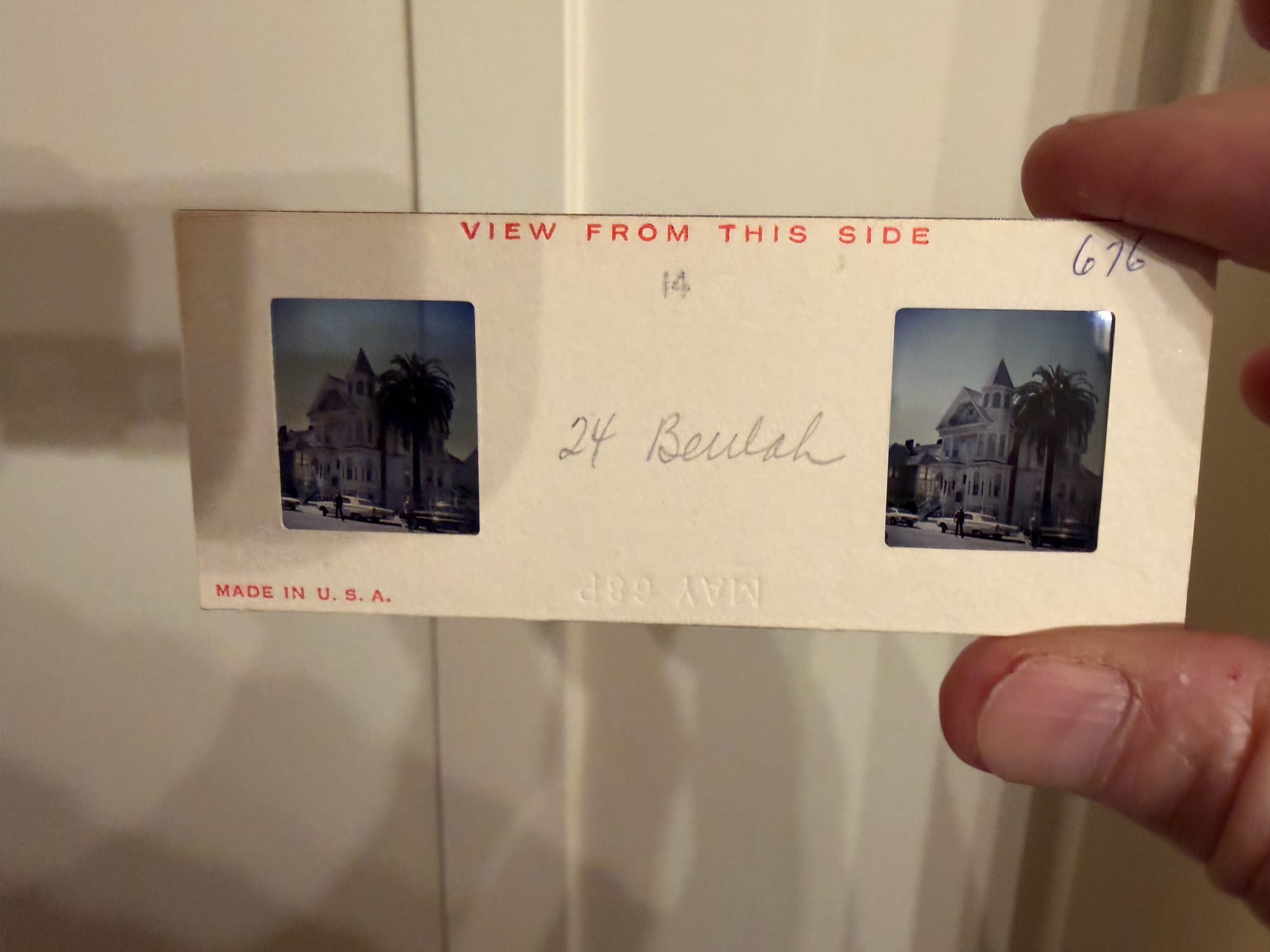 Close-up of a stereoview slide showing two slightly different images of a Victorian home and heading reading VIew from this side