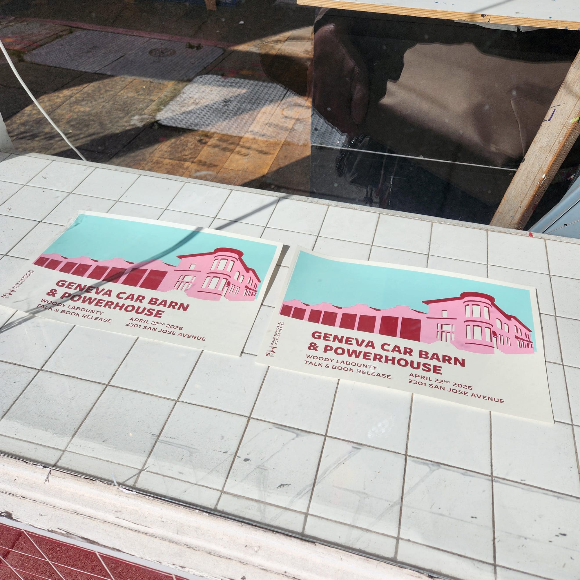 Two 11/17 printed posters showing exterior of Geneva Car Barn in pink with green/blue sky and title Geneva Car Barn & Powerhouse