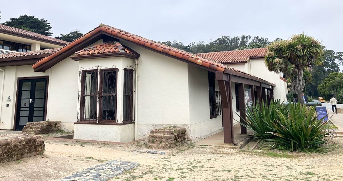 One-story Spanish Colonial structure with red tile roofing.