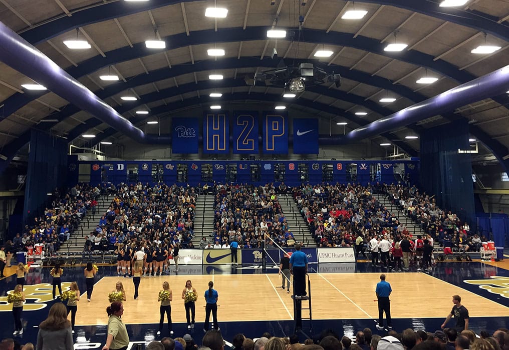 Photo shows a sold out set of stands behind a volleyball court at Fitzgerald Field House in 2018