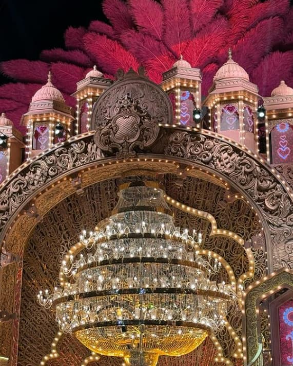 A stunning indoor lighting setup comprising a massive crystal chandelier and sign lights