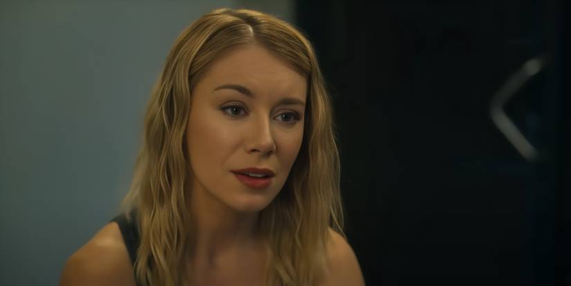 A blond woman looking pensively at another subject off camera.