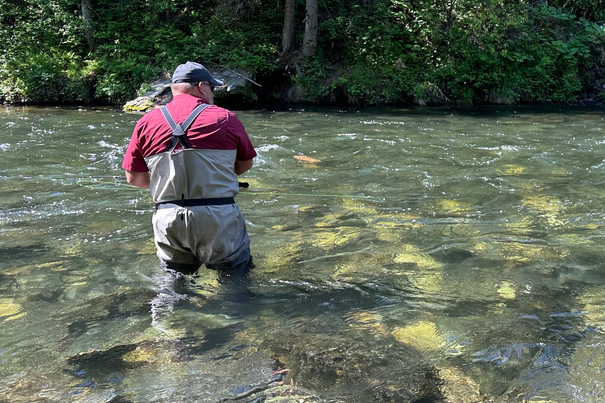 The author wearing the repaired gray fishing waders while salmon fishing in an Alaska river