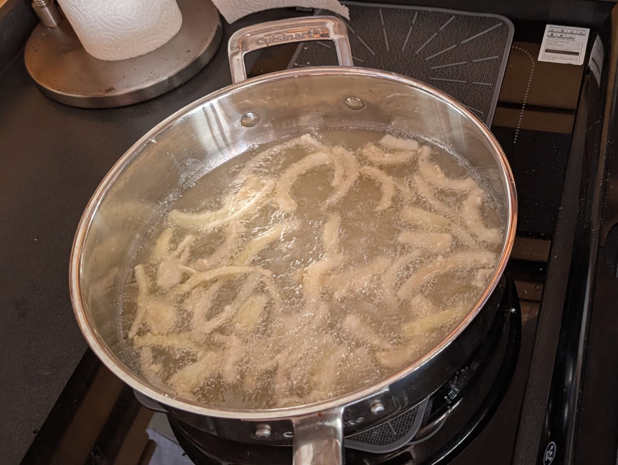 Cuisinart SmartNest stainless stockpot boiling noodles on the boat's induction cooktop