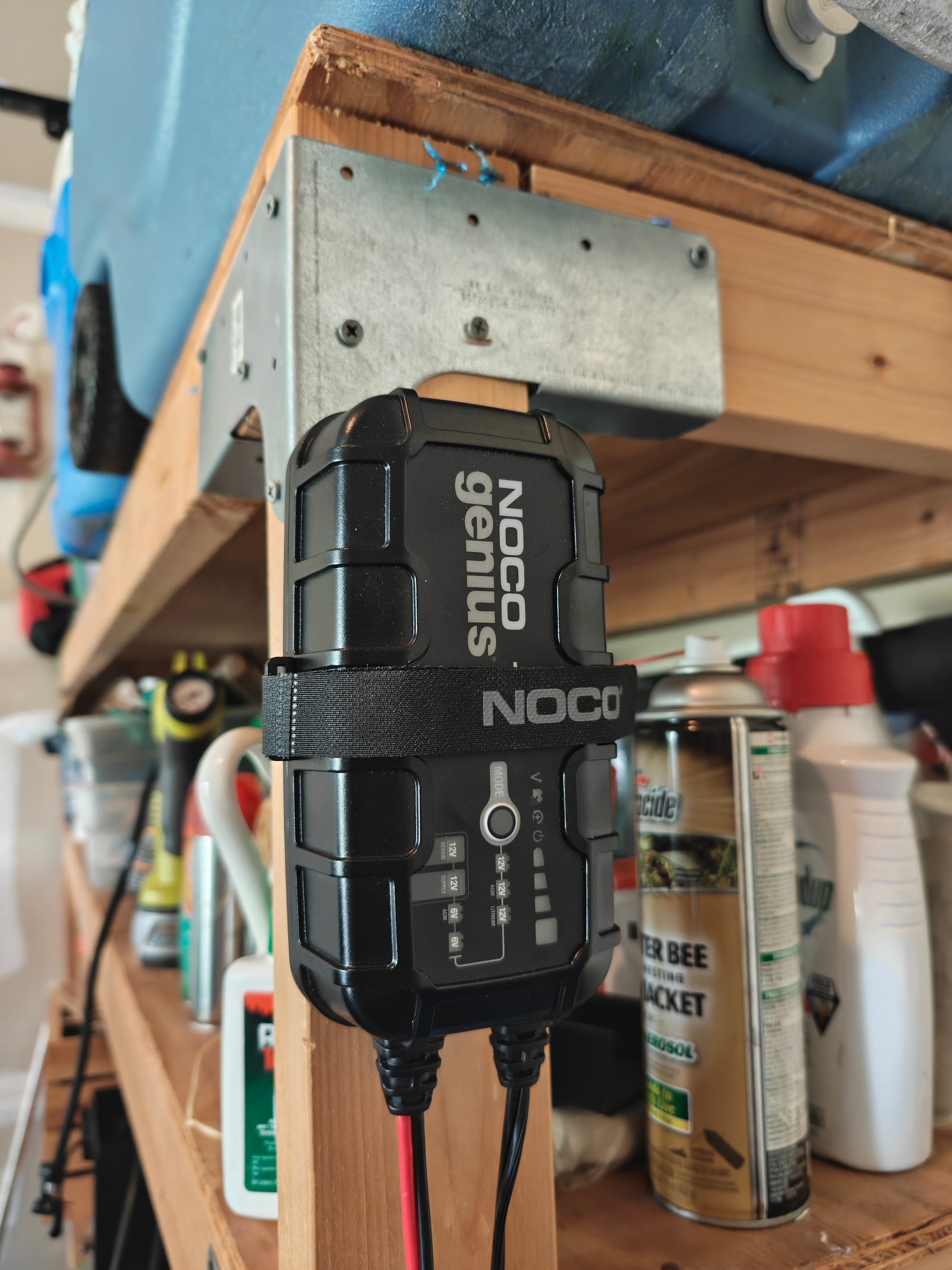 Our NOCO GENIUS10 secured to garage shelving with its included mounting strap