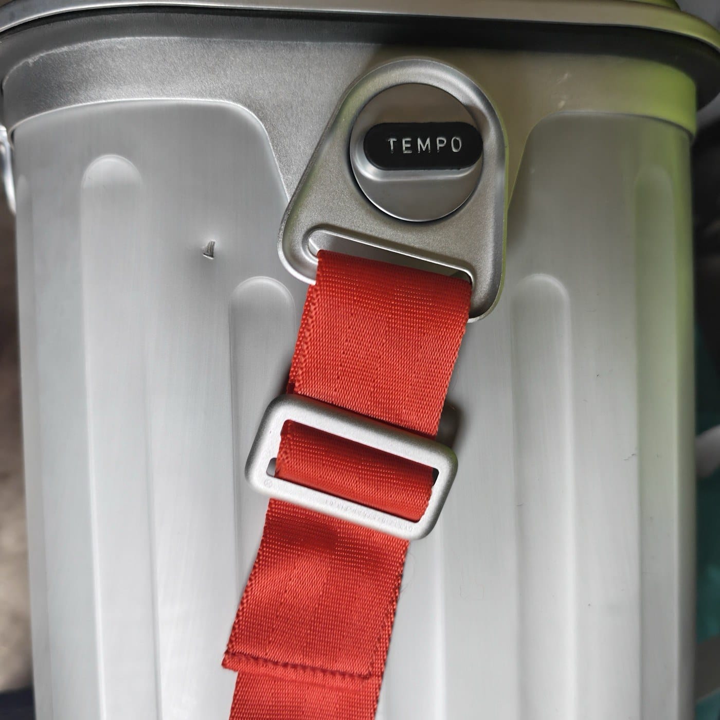 Close-up of the red shoulder strap and a small ding in the aluminum shell of our Oyster Tempo cooler
