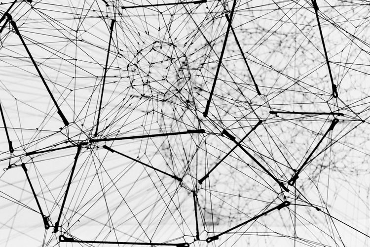 Connected wires and cables in a broken system of geometric shapes and sizes.
