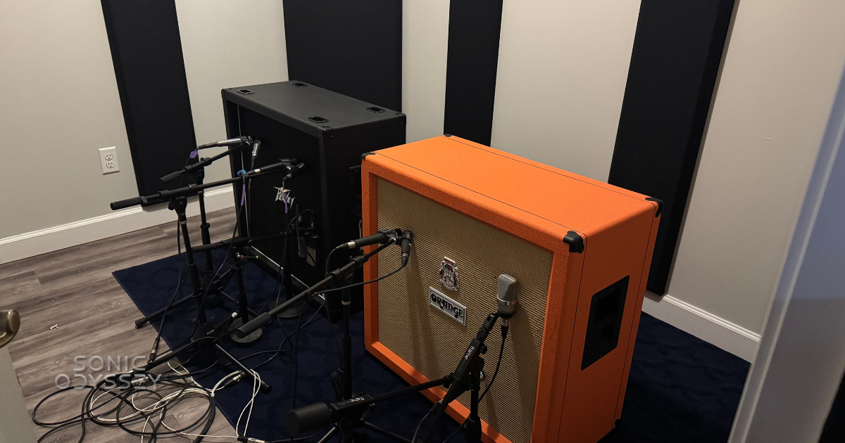 The Room of Doom guitar recording setup with multiple microphones placed on an Orange guitar cabinet and a black cabinet in an isolated studio space.