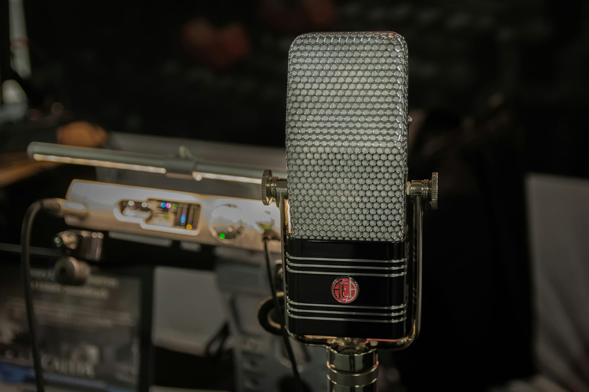 Vintage ribbon microphone with classic grille design, known for its smooth, natural sound in studio recording.
