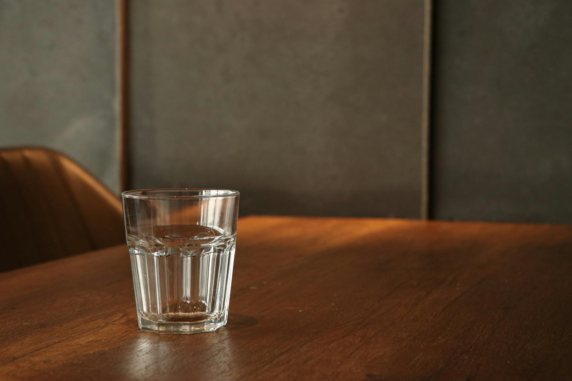 A glass of water on a table.