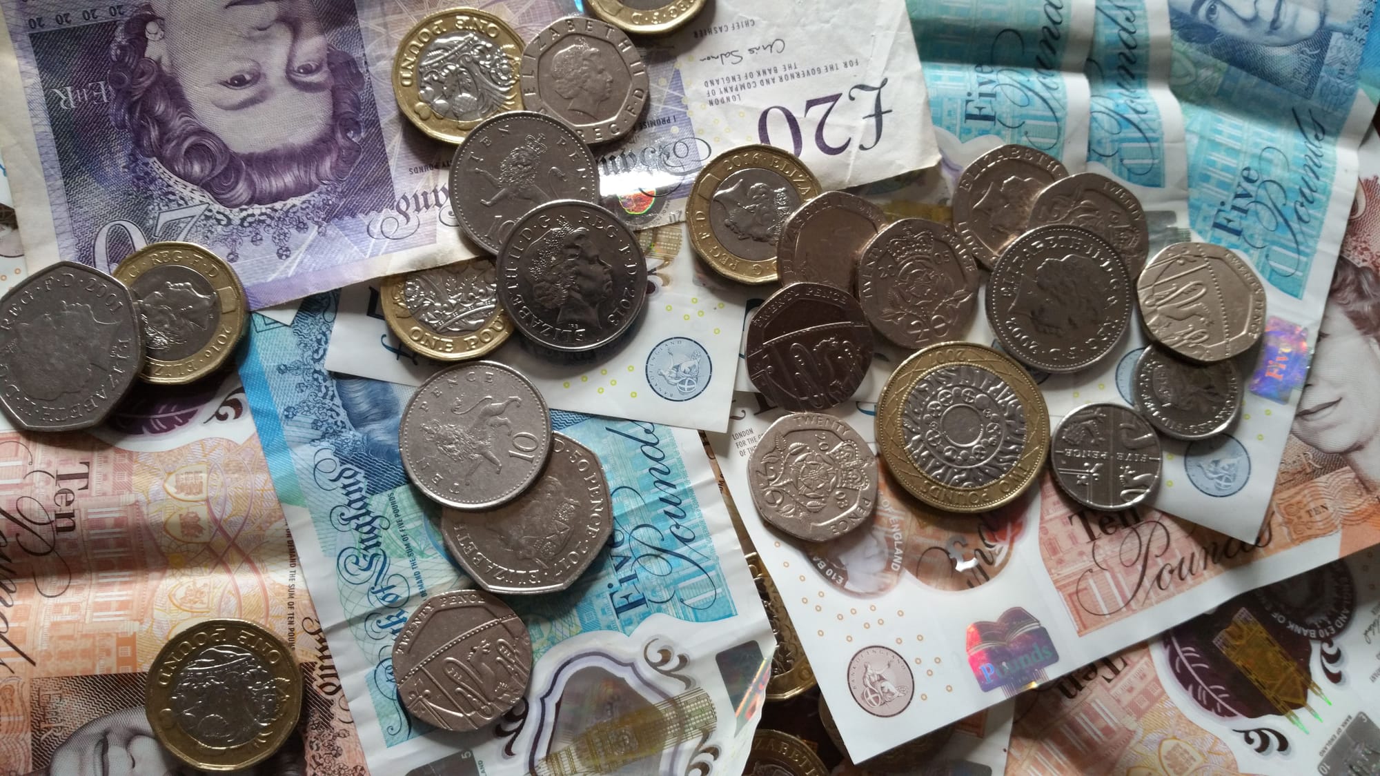 A pile of bank notes and coins.