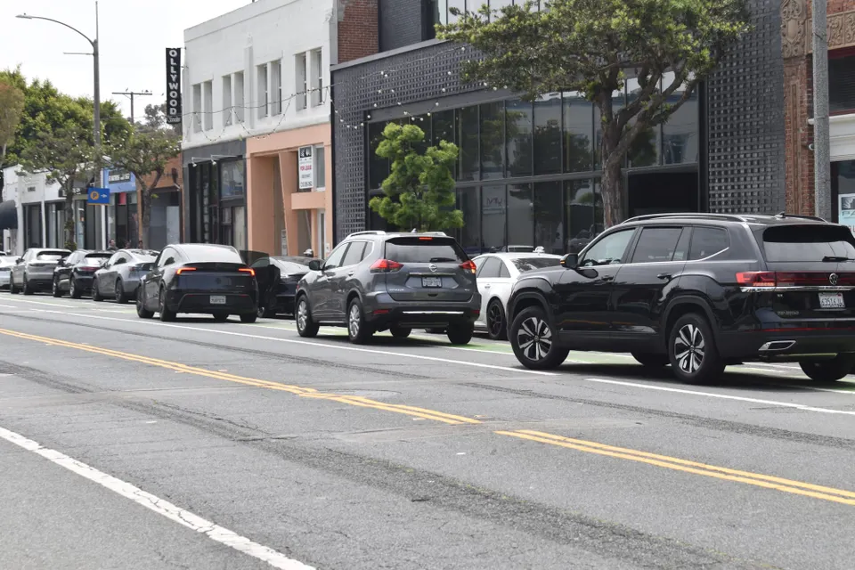 3 cars blocking bike lane
