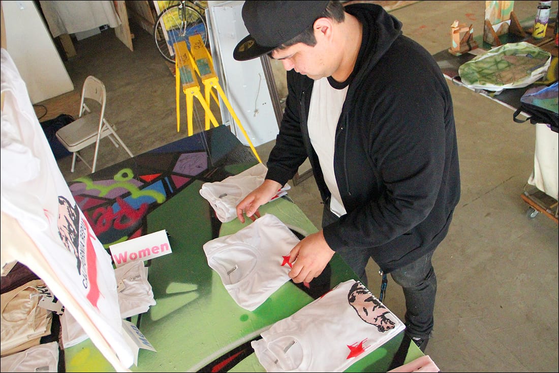 Artist Bobby Rodriguez on Wednesday folds one of the shirts he created for Streetcraft L.A., a pop-up shop that has opened its doors on Main Street. (Photo by Daniel Archuleta)