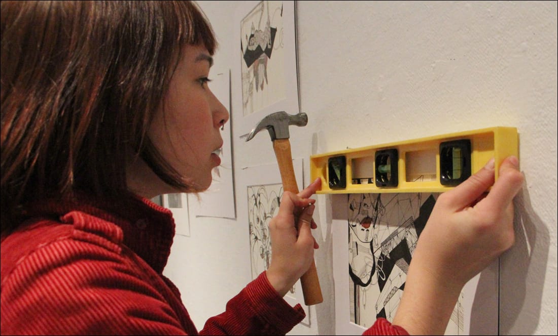 STRAIGHT: Recent Samohi grad Zoe Blue hangs her artwork at the school's Roberts Art Gallery on Monday. (Photo by Daniel Archuleta)